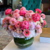 Pink and peach mixed flower arrangement in a glass vase