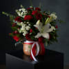 A timeless and elegant arrangement featuring rich red roses, white lilies, and
