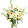 Pink roses and yellow tulips in a clear glass vase
