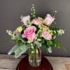 A sweet arrangement of roses, lisianthus, and asters, perfect for so many
