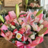 Pink lily and rose bouquet wrapped in bright pink paper