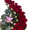 Red roses with pink lilies and chocolate truffles in a floral arrangement