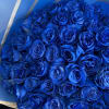 Bouquet of vivid blue roses wrapped in blue paper