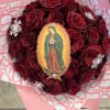 Heart-shaped bouquet of red roses with a religious centerpiece