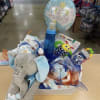 Baby gift basket with a plush elephant, balloon, and assorted infant items