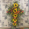 Cross-shaped floral spray with sunflowers, orange roses, and lilies