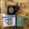 Three novelty mugs with EMT and nurse designs on a shelf