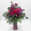 Red roses and purple flowers in a burgundy vase