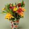 Mixed autumn flowers in a leaf-patterned metal pot