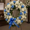 A an open wreath with a mixture of fuji mums, carnations, roses