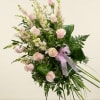 A mixture of Pink gladiolas or pink larkspur, pink roses, tea leaves