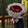 Large bouquet of red roses wrapped in white paper