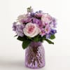 Pink and lavender mixed bouquet in a purple glass vase