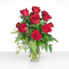 Red roses arranged in a clear glass vase