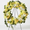 Yellow and white floral wreath on a black stand