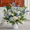 Blue and white floral arrangement in a white vase
