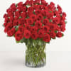 Large bouquet of red roses in a clear glass vase