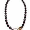 Black beaded necklace with a gold clasp on a white background
