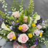 Soft pink roses and white calla lilies create a gentle, garden-fresh look