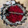 50 red roses with personalized ribbon and baby's breath wrapped in black