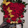 Petals of the heart. Heart made of red roses with chocolates, butterflies.