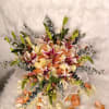 Bouquet of peach roses and white lilies with eucalyptus accents