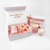 Birthday gift boxes with pink flowers and candles