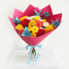 Bright mixed bouquet of roses and chrysanthemums wrapped in pink paper with a blue ribbon