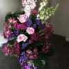 Tall bouquet of pink, purple, and white flowers with dark foliage