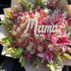 A lush display of pink and white roses accented with pink lilies