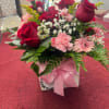 Deep red roses and soft pink carnations combine with pale pink gerbera