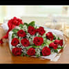 Bouquet of red roses with baby's breath wrapped in white paper