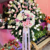 Large standing floral spray with pink and white roses and lilies