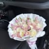 Pink and white roses with tulips in between them .