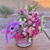 Beautiful flower arrangement with a cute plushy.