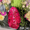 Bright pink rose and gerbera floral arrangement with cream roses