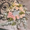 Circular floral wreath with pink and cream roses and calla lilies