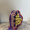 Heart-shaped candy arrangement with chocolate bars and gold-wrapped chocolates