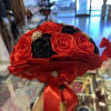 Bouquet of red and black roses with a red satin ribbon