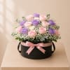 This graceful floral design features 18 roses in blush, lavender, and ivory