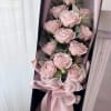 Bouquet of pale pink roses in a black gift box with ribbon