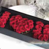 Red roses arranged in a black gift box to form the number 520