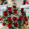 Basket arrangement of red roses with white filler flowers