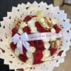 Red and white rose bouquet with butterfly decorations and a ribbon