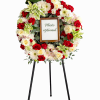 Floral wreath on a stand with a photo frame in the center