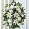 A timeless and elegant white standing spray designed to honor and celebrate