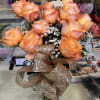 1 dozen coral roses, baby's breathe with greenery. 