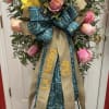 Pink roses and yellow lilies on a stand. Colors may vary. 