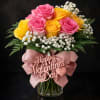 6 pink and 6 yellow roses arranged in greenery and a beautiful