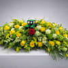 Yellow and white roses with greenery and John Deere tractor.  Tractor